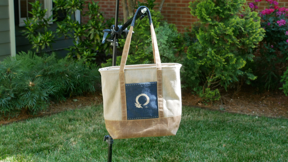 Front view of the JP Marston Enso Rabbit Tote Bag, a waxed canvas tote with the brushed enso circle and leaping rabbit on a navy Japanese print pocket