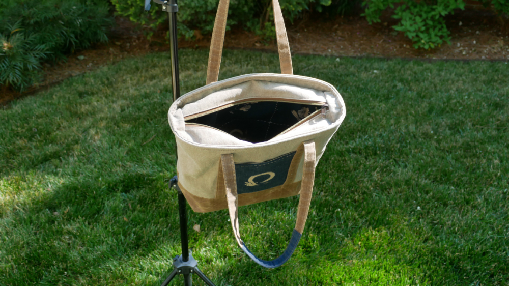 Inside the Enso Rabbit Tote Bag showing the rabbit-print interior lining, full-length top zip closure, and waxed canvas construction